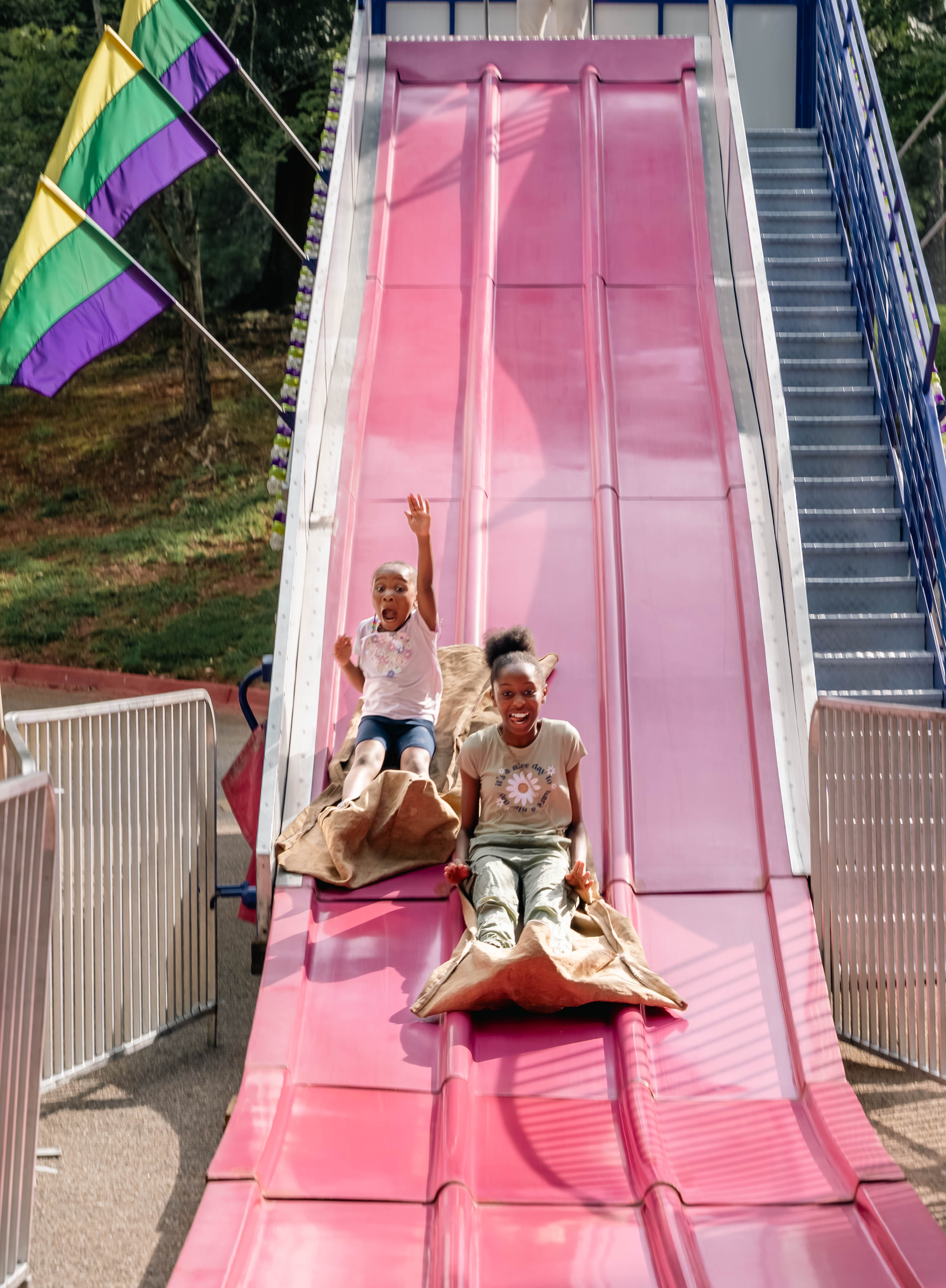 Kids smiling on slides at Turbo Day 2025